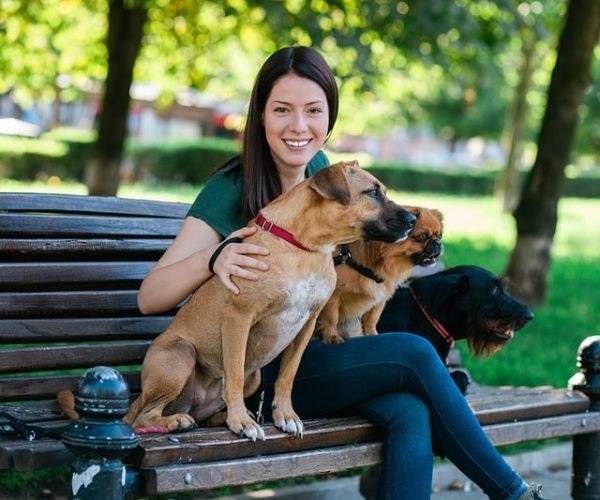 woman-smiling-with-dogs woman-smiling-with-dogs